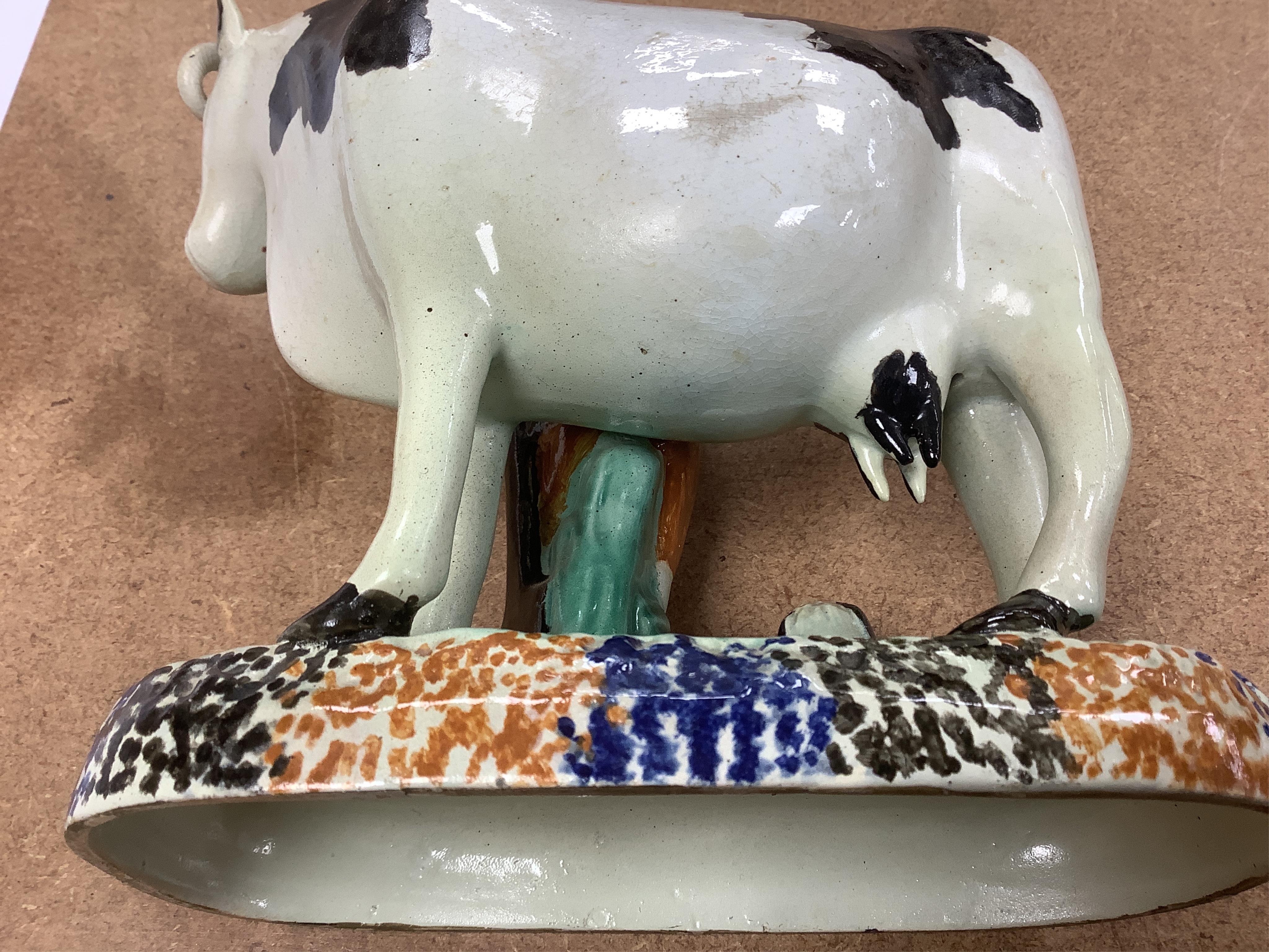 Two Yorkshire Prattware cows, with farmer or milkmaid and dog groups, c.1810